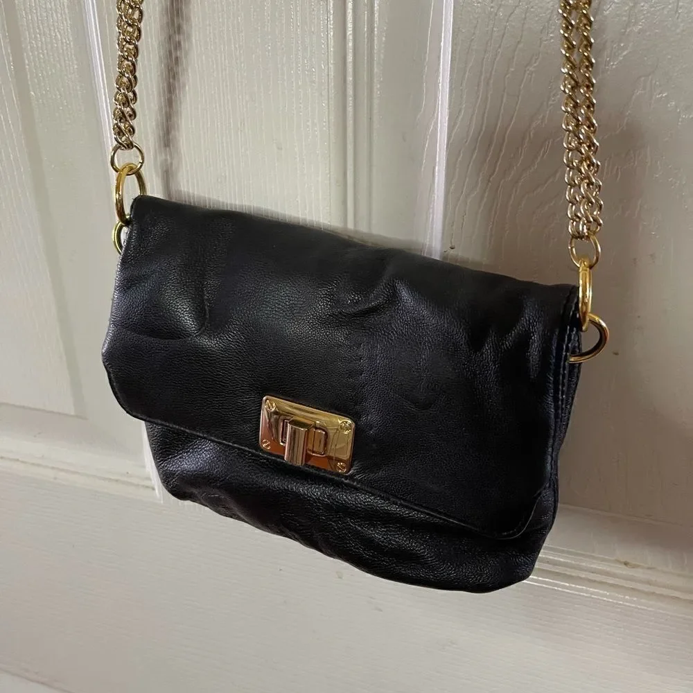 Paradox leather black small crossbody bag with ajustable gold tone chain.